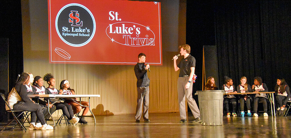 St. Luke's varsity girls basketball competes in a trivia game during their pep rally.