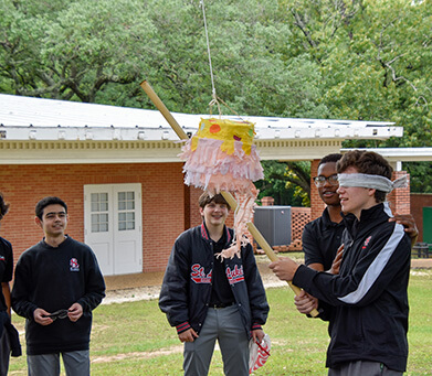 St. Luke's Spanish 1 students finish off the year by smashing pinatas filled with candy.
